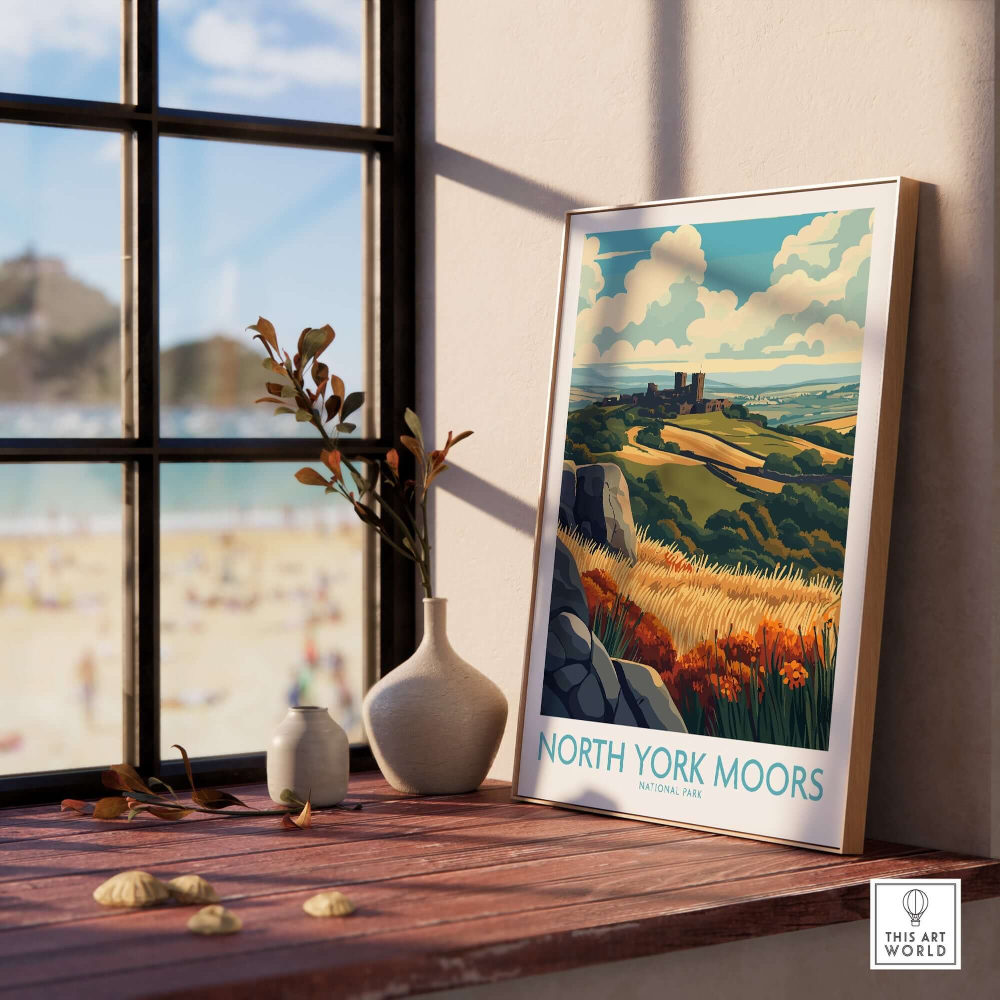 North York Moors Poster displayed in a sunlit room with a view of the beach and decorative items on the table.