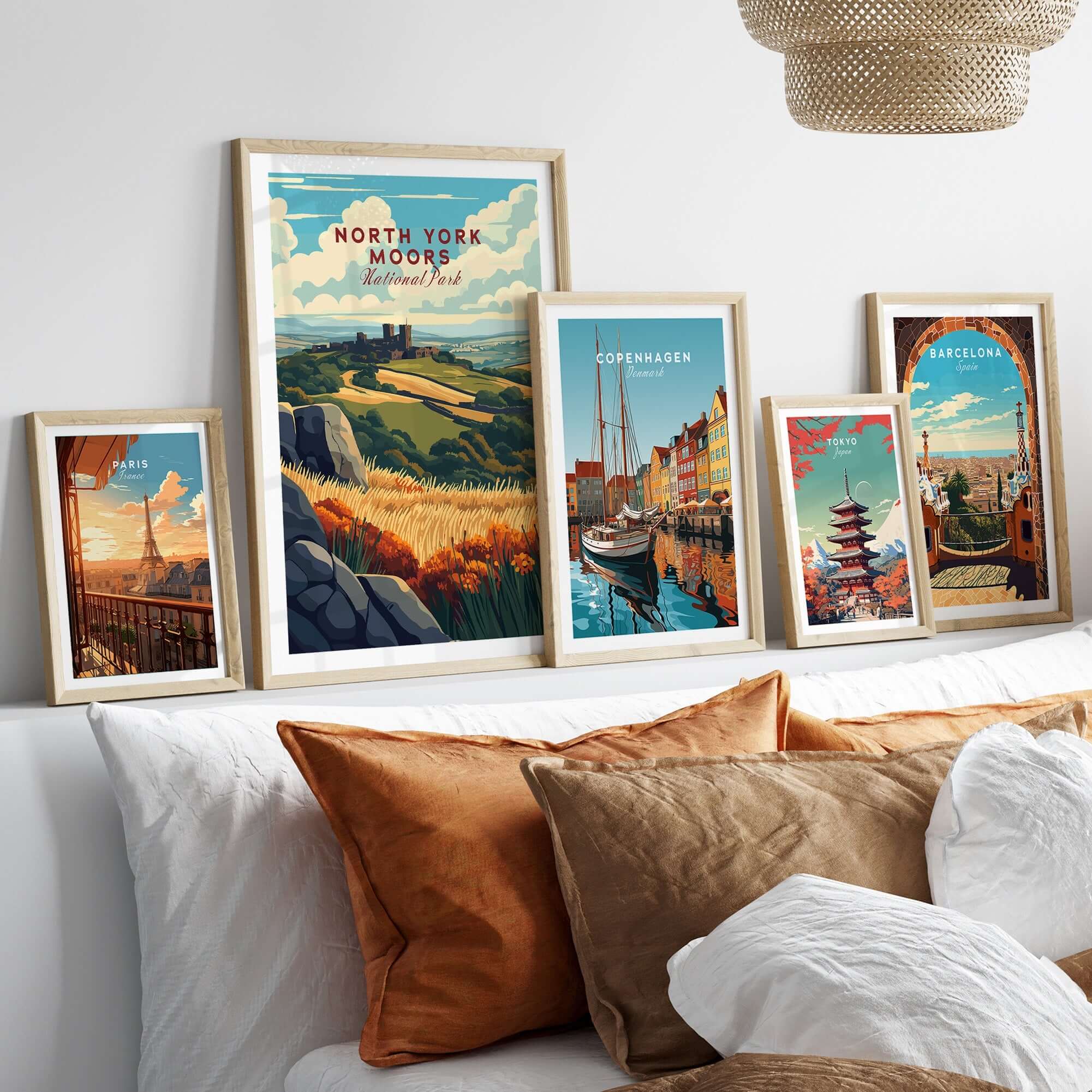 North York Moors Print showcased among various framed travel art prints on a stylish bed.