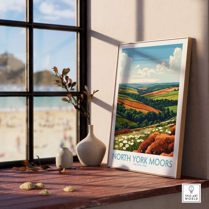 North York Moors travel poster displayed on a table with a scenic view through the window, capturing lush landscapes.