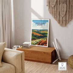 North York Moors Travel Print displayed in a cozy living room, capturing the landscape's vibrant colors and charm.