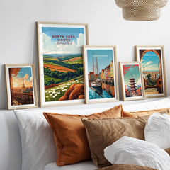 North York Moors Travel Print displayed among other travel prints in a cozy living room setting with decorative pillows.