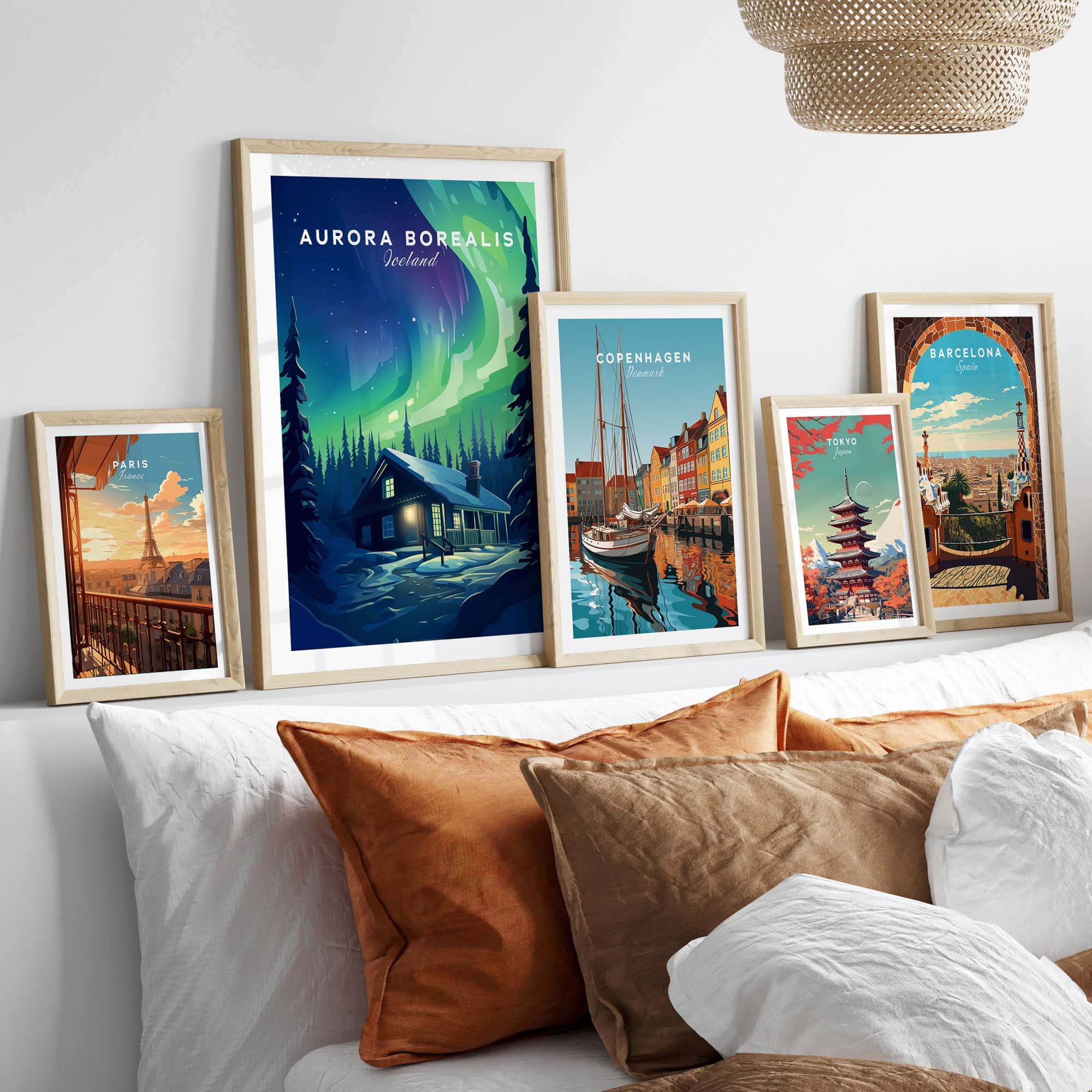 Framed Northern Lights Print and cityscape wall art displayed on a cozy sofa in a living room setting.