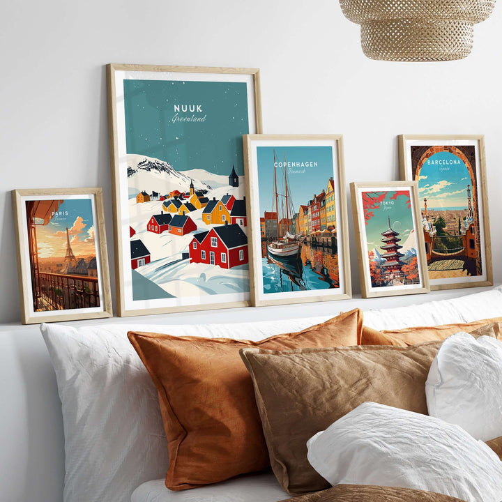 Colorful framed prints of Nuuk, Copenhagen, and Barcelona art displayed above a stylish bed with decorative pillows.