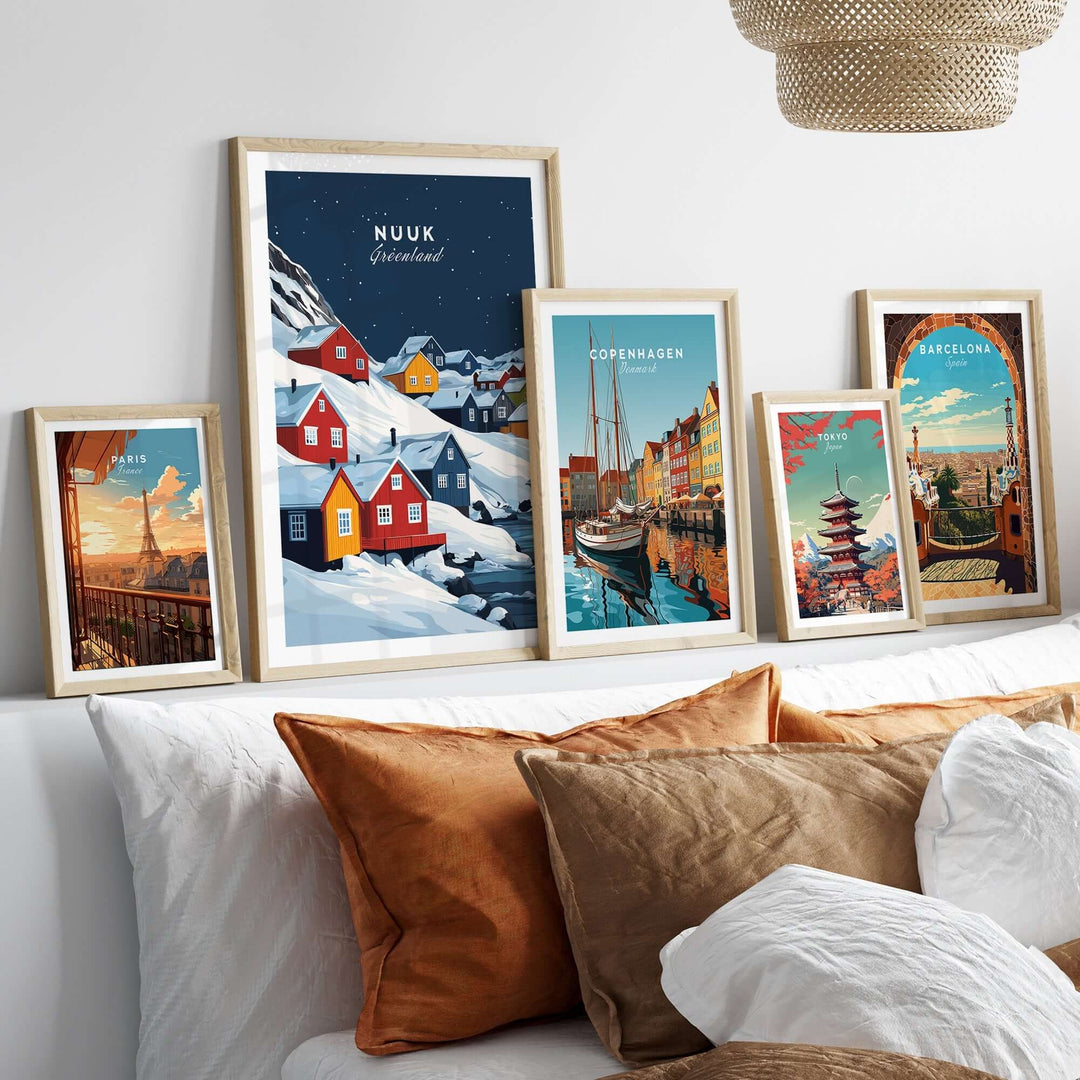 Colorful Nuuk Greenland wall art displayed above a cozy sofa, showcasing vibrant landscapes and city scenes in elegant frames.