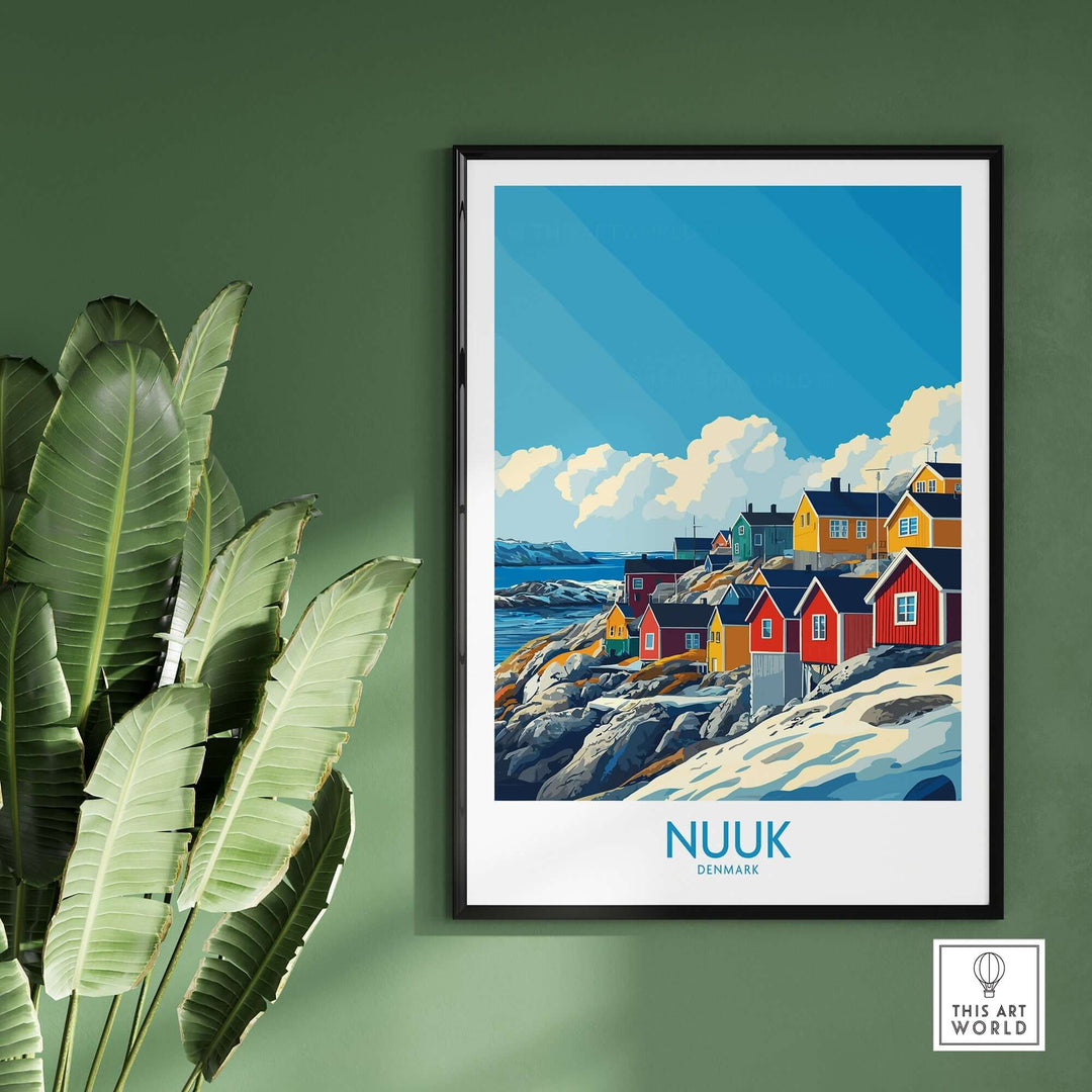 Nuuk travel poster featuring colorful houses by the sea, framed on a green wall with plants in the background.