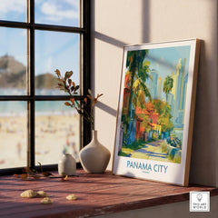 Framed Panama City travel poster with palm trees and skyline, displayed on wooden windowsill near beach view.