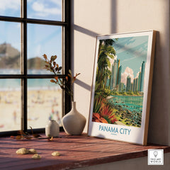 Framed Panama City travel poster with tropical skyline, palm trees, and coastal view, displayed on wooden windowsill.