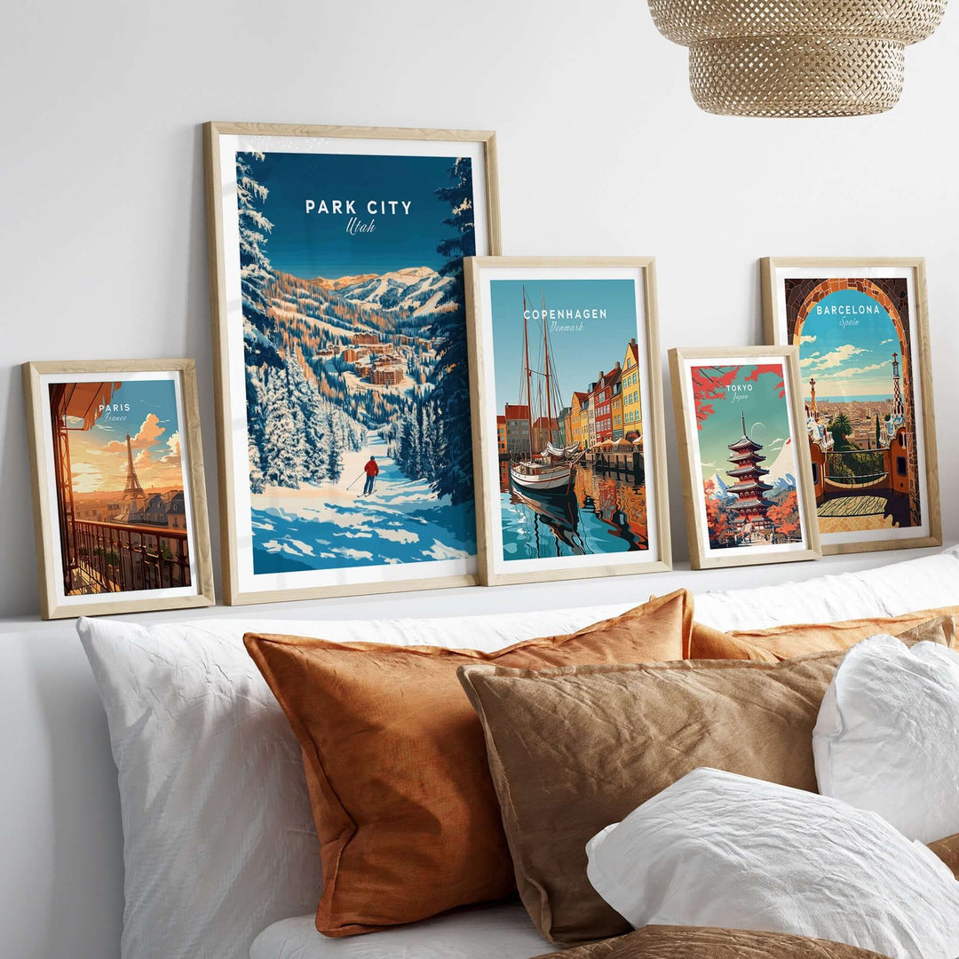 Park City ski art print displayed among other city prints above a cozy couch with decorative pillows.