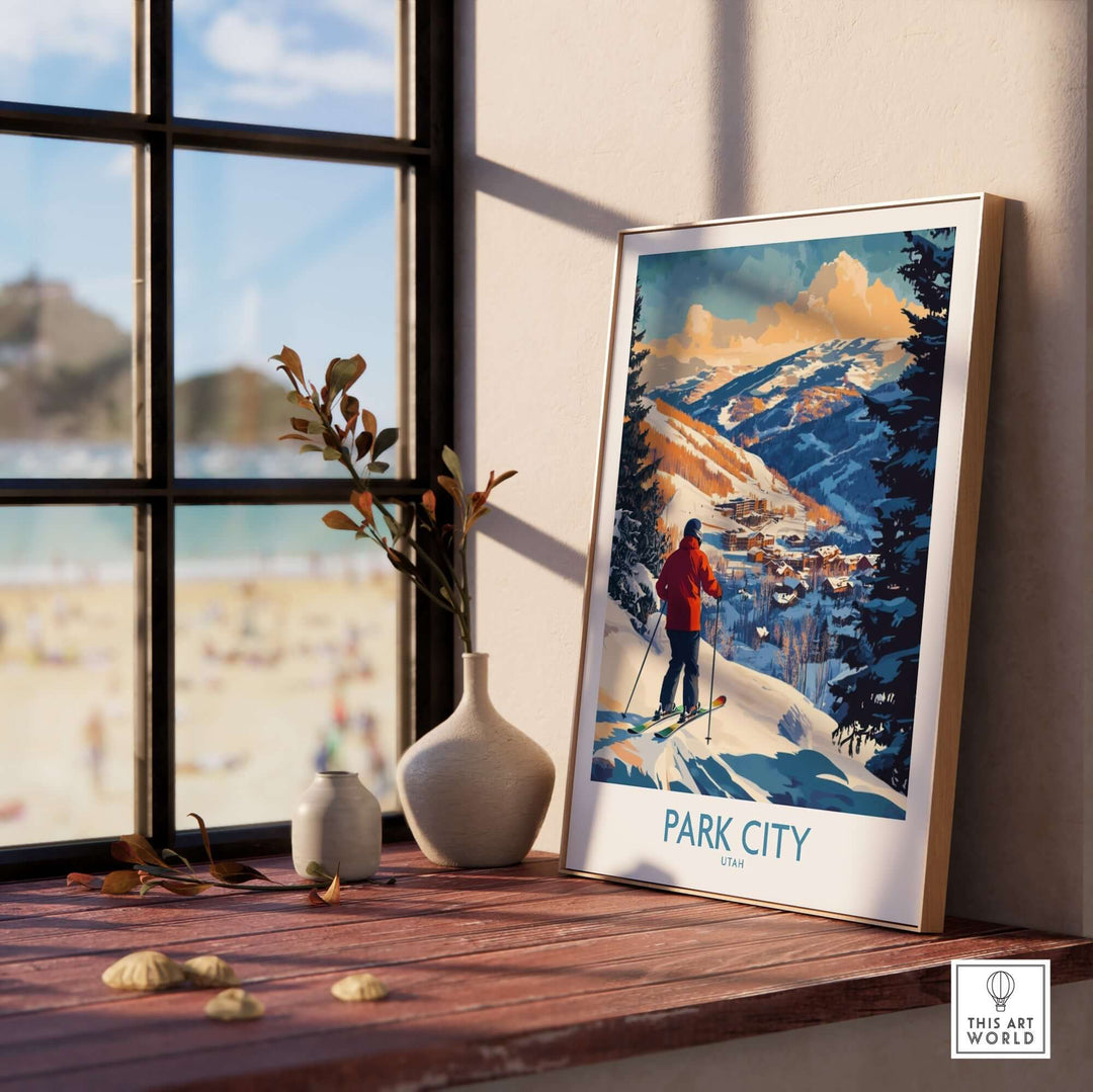 Park City Ski Wall Art poster displayed on a windowsill, showcasing winter landscapes and a skier in vibrant colors.