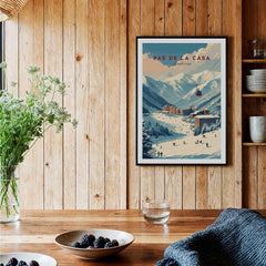 Pas de la Casa Winter Village and Slopes Print | Ski Wall Art displayed in a cozy wooden room with plants and tableware.