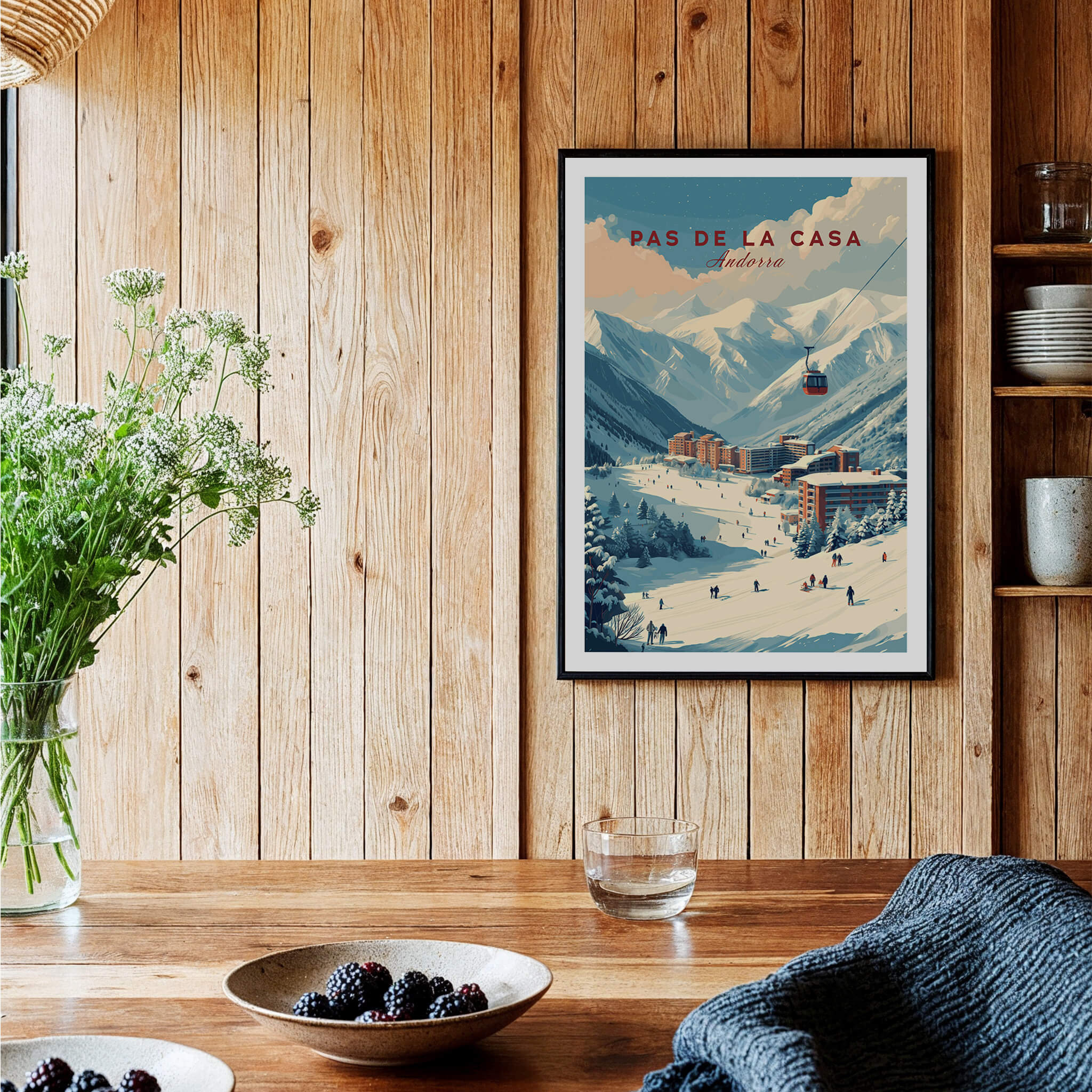 Pas de la Casa Winter Village and Slopes Print | Ski Wall Art displayed in a cozy wooden room with plants and tableware.