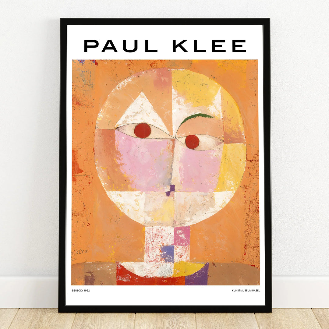 Paul Klee abstract face art print with geometric shapes in a black frame against a wall