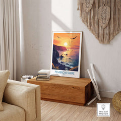Pembrokeshire Coast Wales Wall Art Print showcasing a vibrant sunset over the coastline in a cozy interior setting.