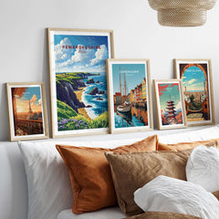 Pembrokeshire Print showcased among framed artwork on a stylish bed, featuring stunning coastal views.