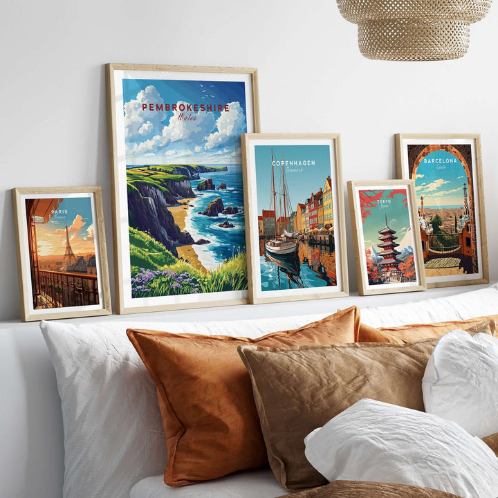 Beautiful Pembrokeshire print displayed with other city art prints on a cozy bed, adding charm to home decor.