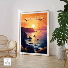 Pembrokeshire Wales Wall Art featuring a vibrant sunset over the ocean in a stylish living room setting.