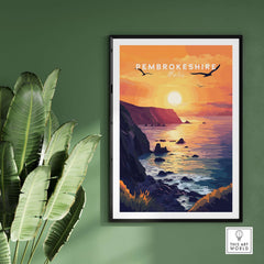 Pembrokeshire Wales Wall Art depicting a colorful sunset over the ocean with cliffs and birds, perfect for home decor.