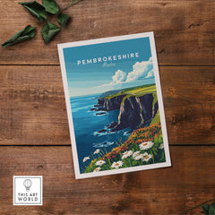 Pembrokeshire Wall Art featuring the beautiful coast of Wales with flowers in the foreground on a wooden background.
