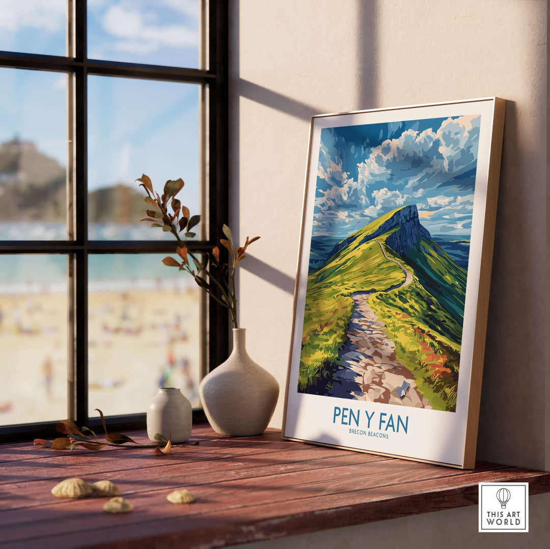 Pen Y Fan poster displayed on a windowsill, showcasing the Brecon Beacons landscape with vibrant colors and scenic beauty.