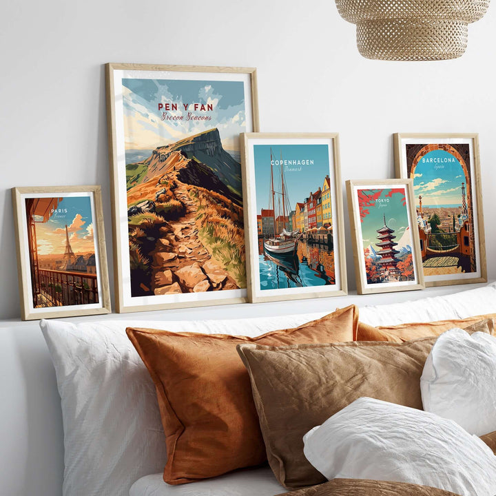 Pen Y Fan travel print framed with other city prints on a cozy sofa, showcasing Welsh landscape art.