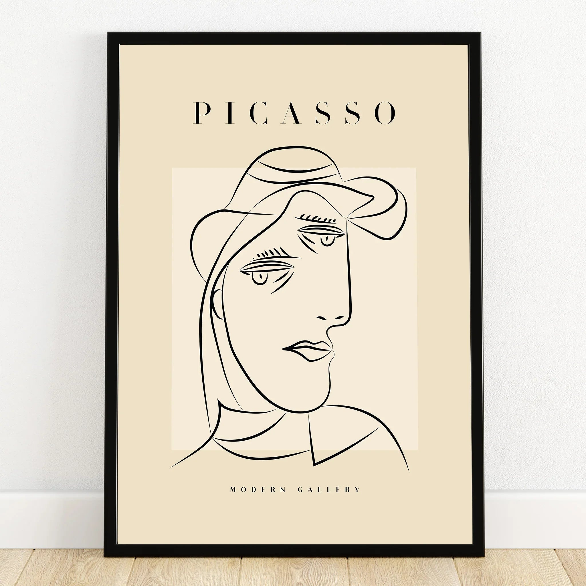 Minimalist Picasso line art portrait poster in black frame on beige background