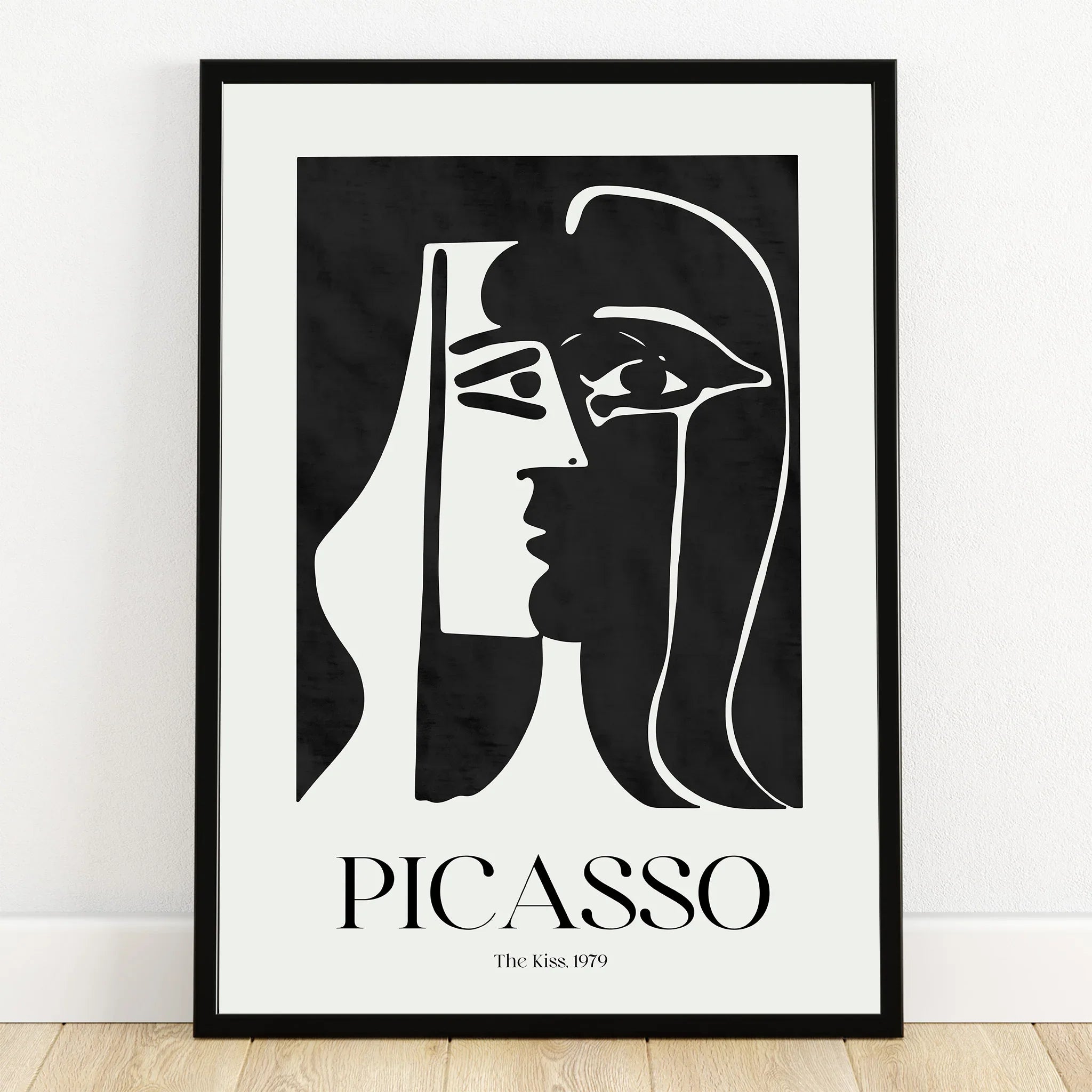 Minimalist Picasso-style black and white abstract face art print in black frame