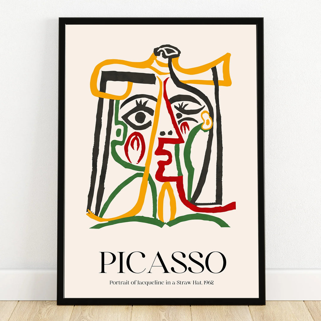 Abstract Picasso-style portrait print with colorful lines in a black frame on a wooden floor.