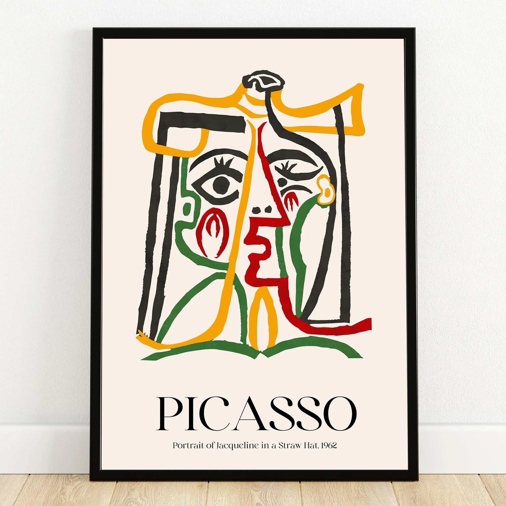 Abstract Picasso-style portrait print with colorful lines in a black frame on a wooden floor.