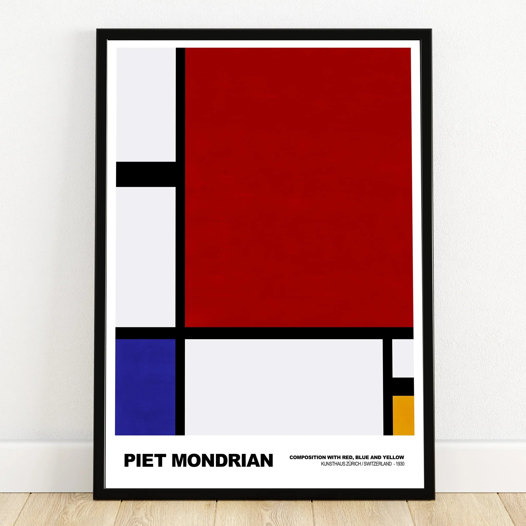 Framed abstract Piet Mondrian print with bold red, blue, yellow, and black geometric shapes.