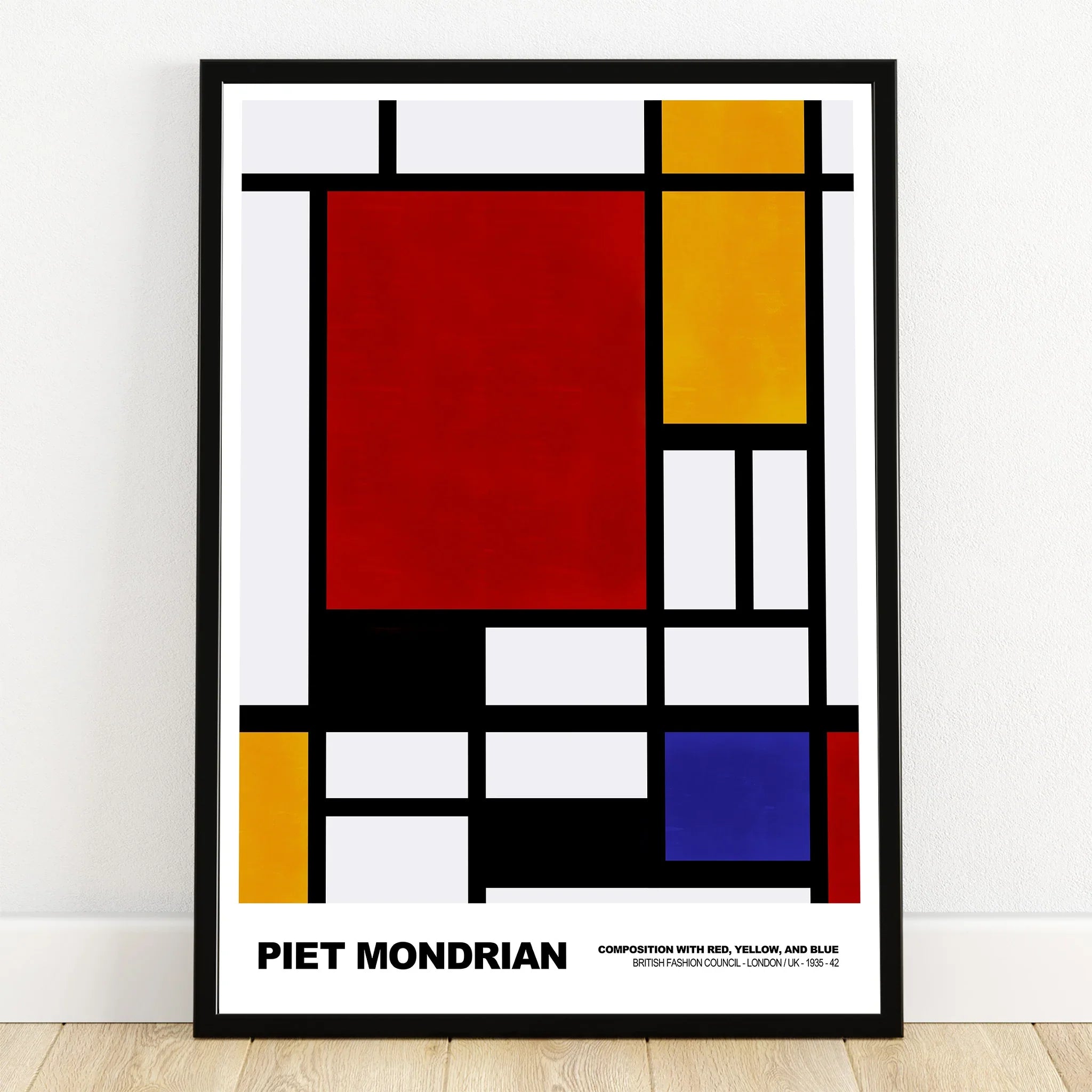 Framed Piet Mondrian abstract art print with red, yellow, blue, and black geometric shapes