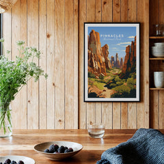 Framed Pinnacles National Park art print on wood wall in rustic kitchen with flowers and berries