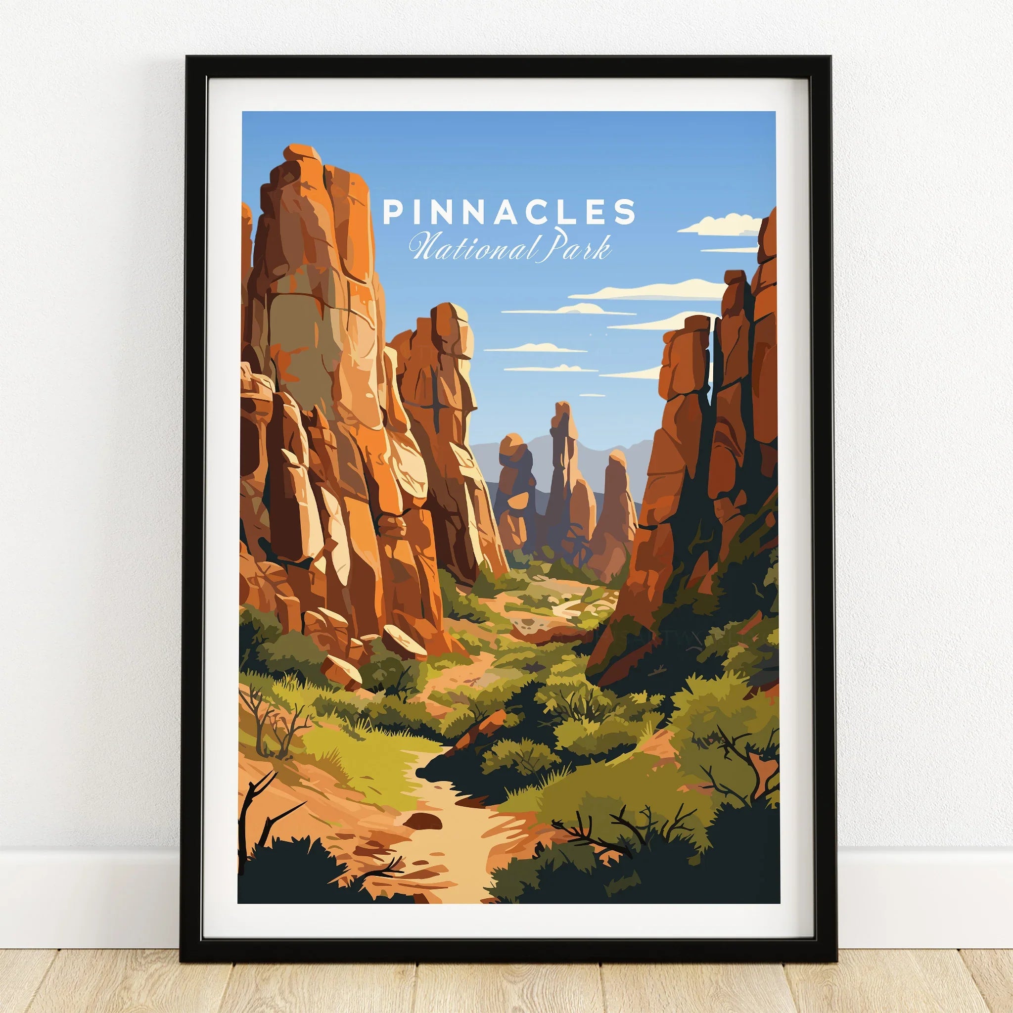Pinnacles National Park art print in black frame, featuring rocky landscape and blue sky.