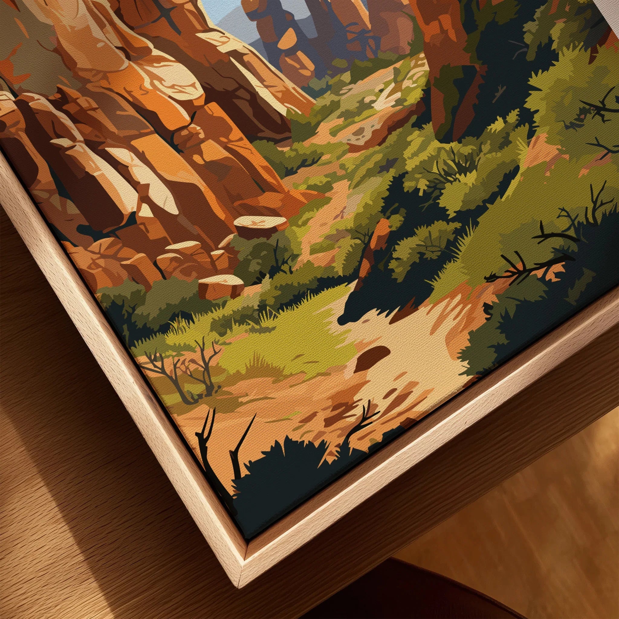 Close-up of framed canvas print with colorful canyon landscape, natural wood frame, wall art