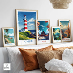 Plymouth Devon Print - Smeaton's Tower Wall Art displayed among other travel-themed prints on a cozy sofa.