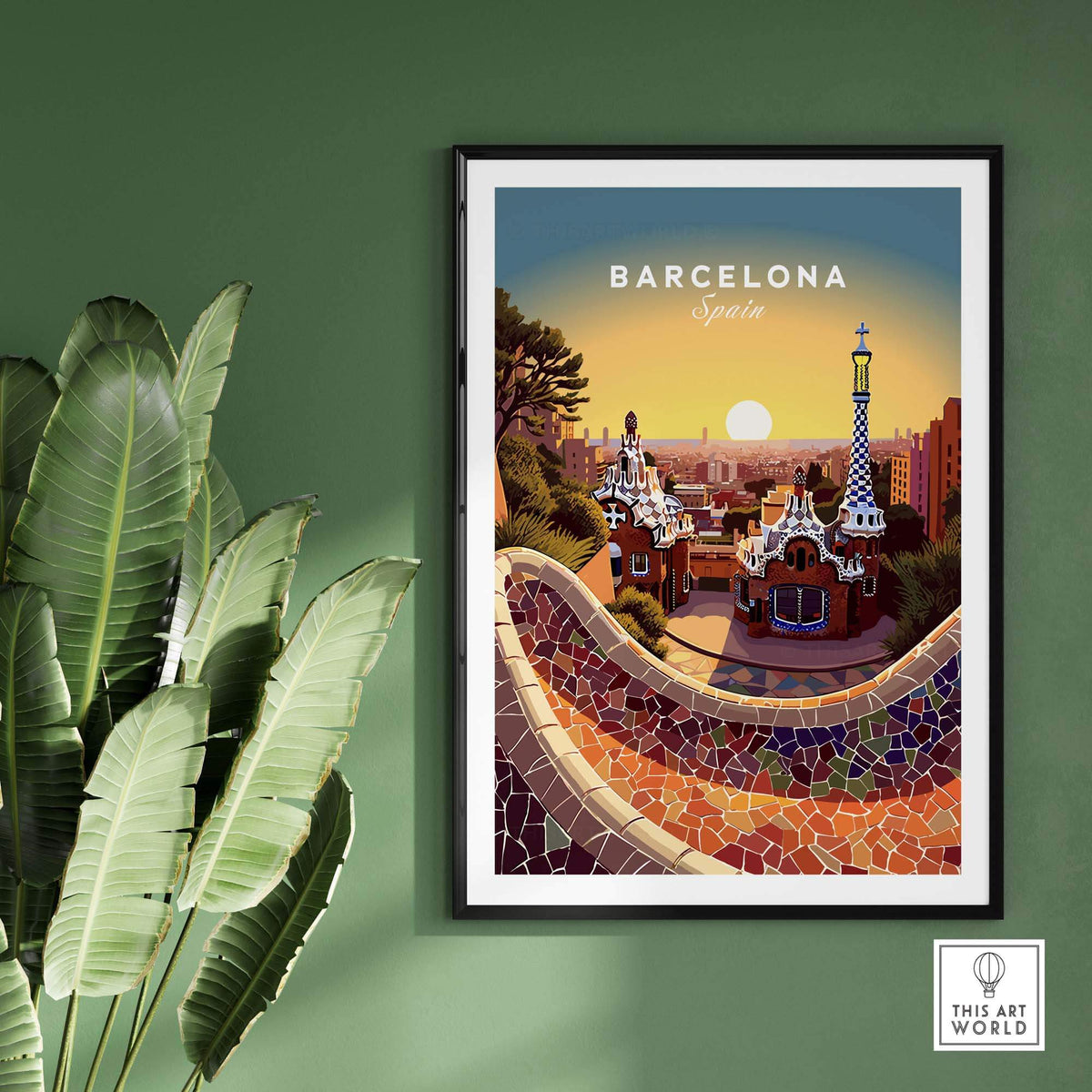 Travel Poster of Barcelona at Sunset featuring the Gaudi wall and shown in a black frame on a green wall with a green plant on the left. 
