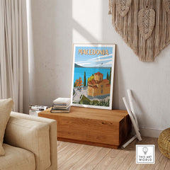 Vibrant Macedonia travel poster print displayed on a wooden box in a stylish living room setting.