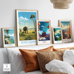 Framed travel posters featuring Queen Elizabeth National Park and other destinations in a stylish living room setting.