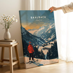 Saalbach Travel Poster - Austria featuring a skier overlooking snowy mountains and a picturesque town.
