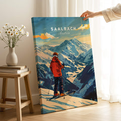 Saalbach Ski Poster- Austria featuring a skier overlooking the mountains in a cozy indoor setting.