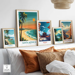 Santa Monica Sunset Wall Art: Beach & Pier Print displayed among various travel-themed art prints in a cozy setting.