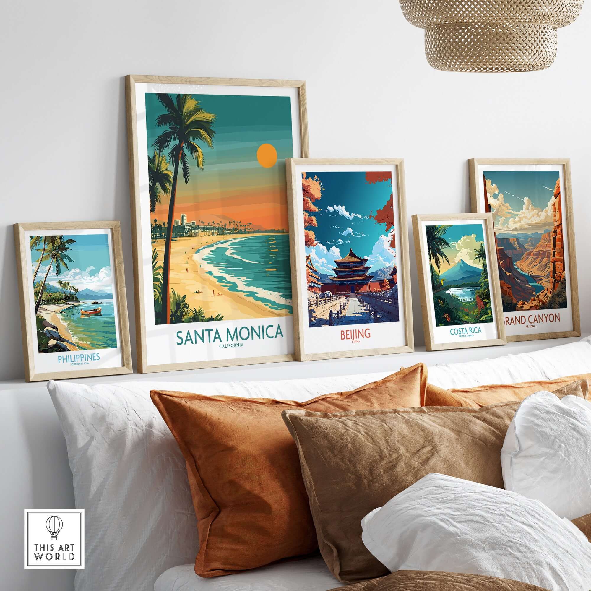 Santa Monica Sunset Wall Art: Beach & Pier Print displayed among various travel-themed art prints in a cozy setting.