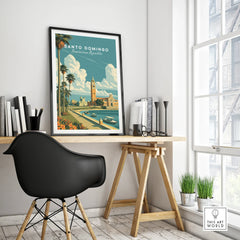 Santo Domingo travel poster with palm trees, historic buildings, and waterfront, framed on desk in modern home office