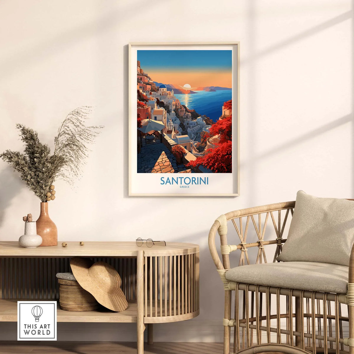 Santorini Art Print framed on a wall above a stylish chair, capturing vibrant colors of the Mediterranean landscape.