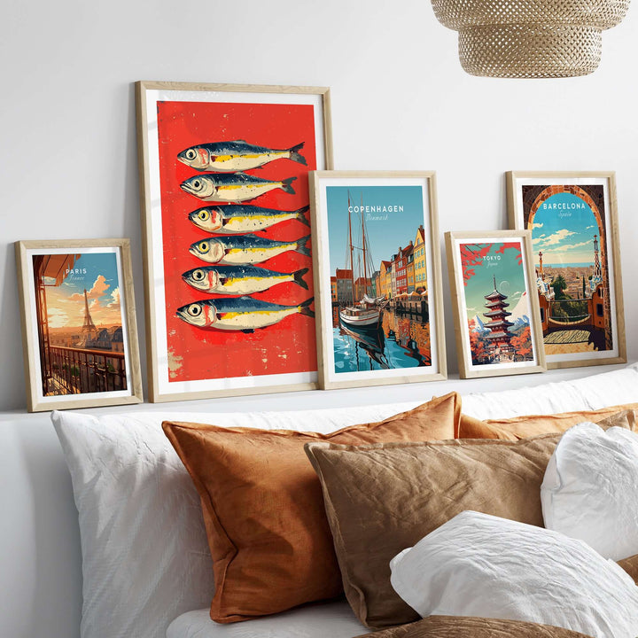 Sardines poster print among framed art pieces on a shelf, enhancing modern kitchen decor with seafood theme.