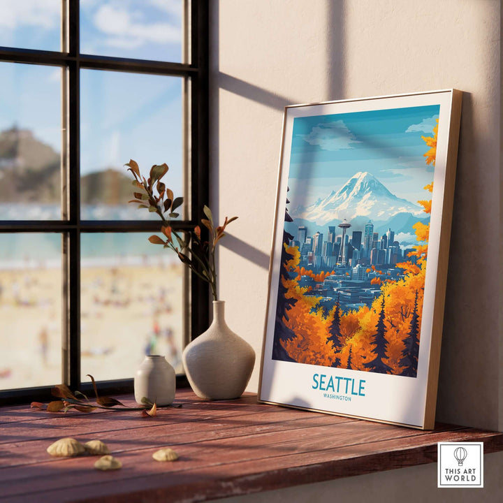 Framed Seattle landmark poster art displayed near a window, showcasing vibrant colors and iconic mountain skyline.