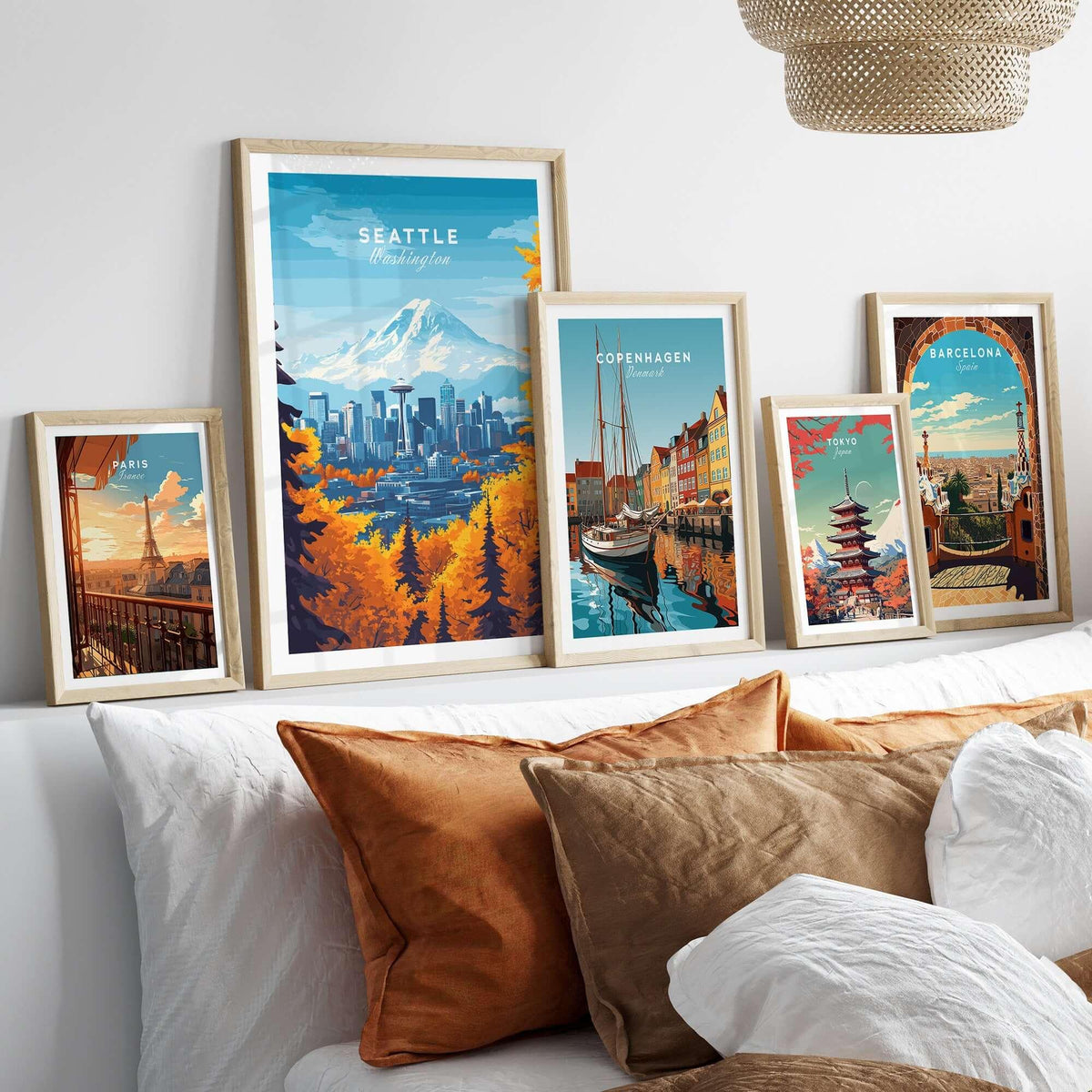 Seattle Skyline Wall Art - Space Needle Travel Poster displayed among other city travel posters on a stylish bed.