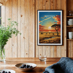 Serengeti National Park art print with sunset landscape in a black frame, displayed in a rustic kitchen setting.