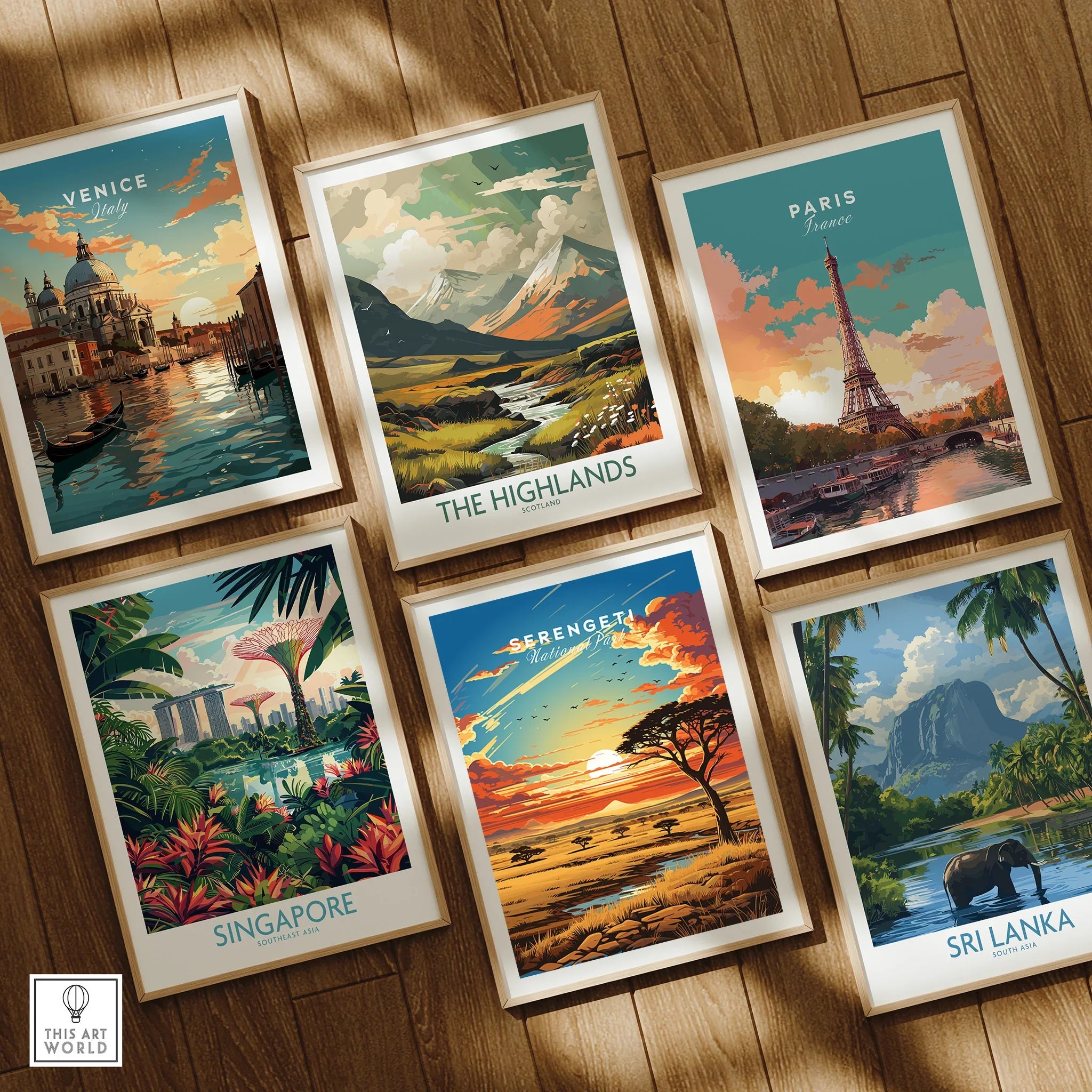 Set of six framed travel posters featuring Venice, the Highlands, Paris, Singapore, Serengeti, and Sri Lanka on wooden floor