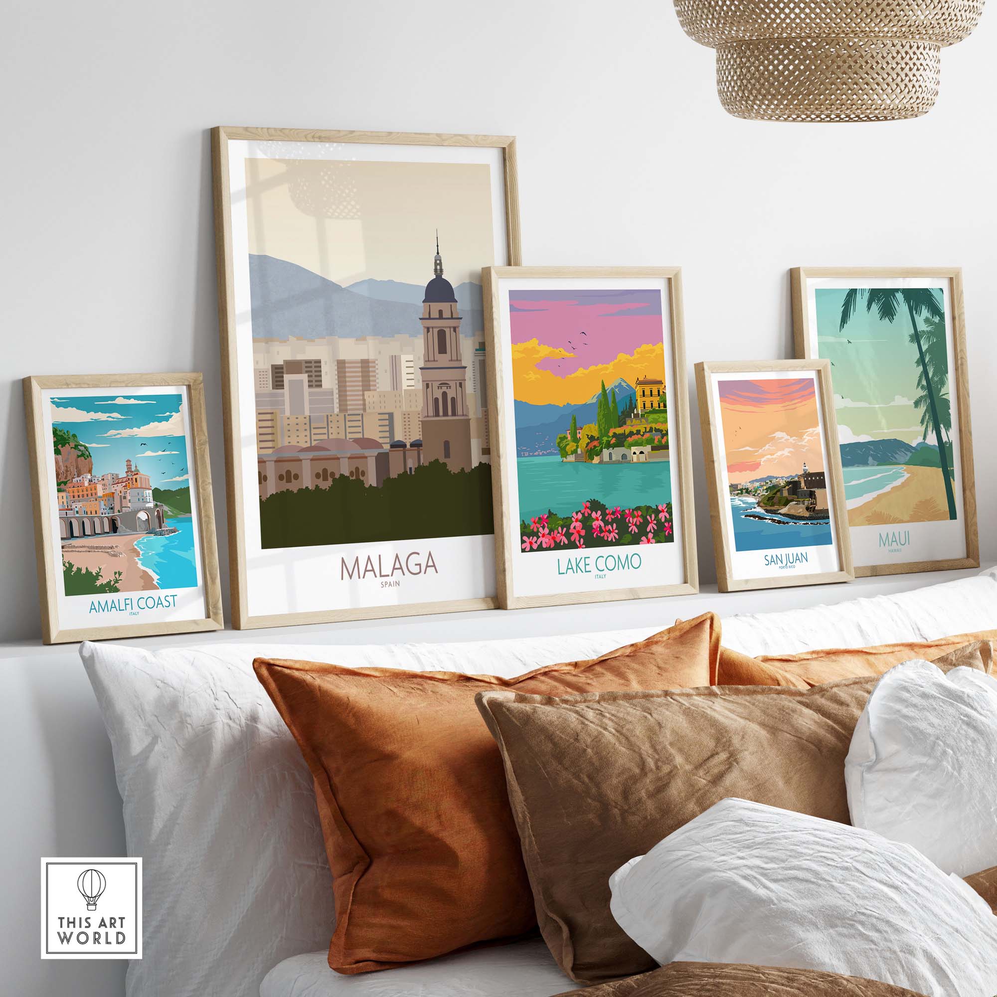 Vibrant Malaga Wall Art Print showcased among framed travel posters, enhancing a stylish living room decor.