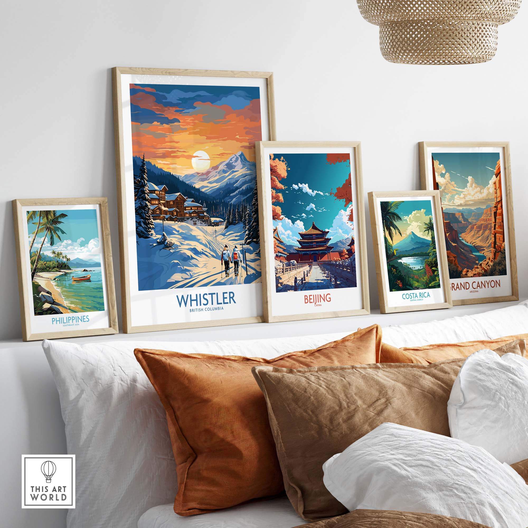 Framed Whistler print alongside other travel posters on a stylish shelf in a cozy home decor setting.